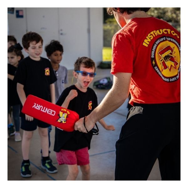 child smiling, practicing martial arts