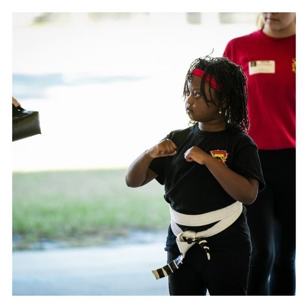 girl practicing martial arts after school