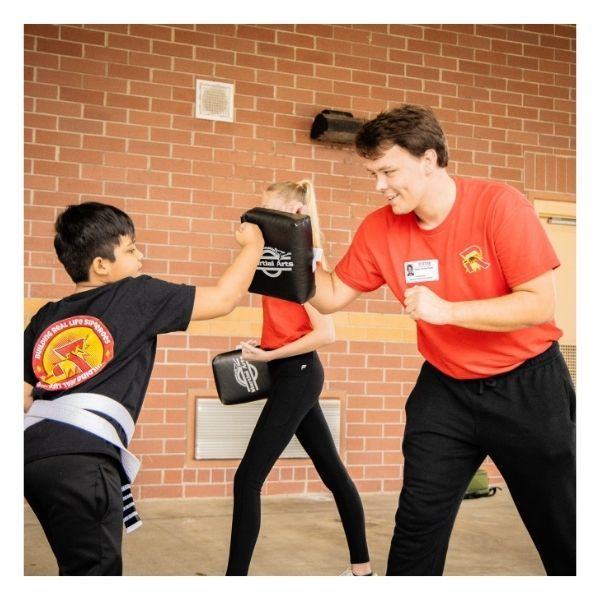 young boy practicing punching