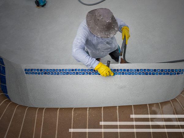 a person cleaning an in-pool seat