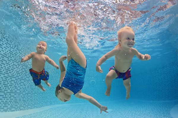 kids enjoying swimming in pool kids in pool