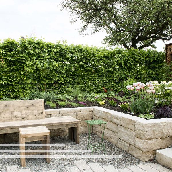 Retaining wall creating a flower bed with a bench in front of it. Retaining wall creating a flower bed with a bench in front of it.