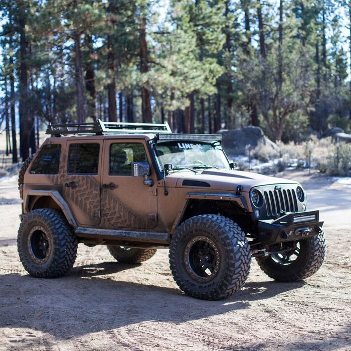a brown jeep with an extended grill protector