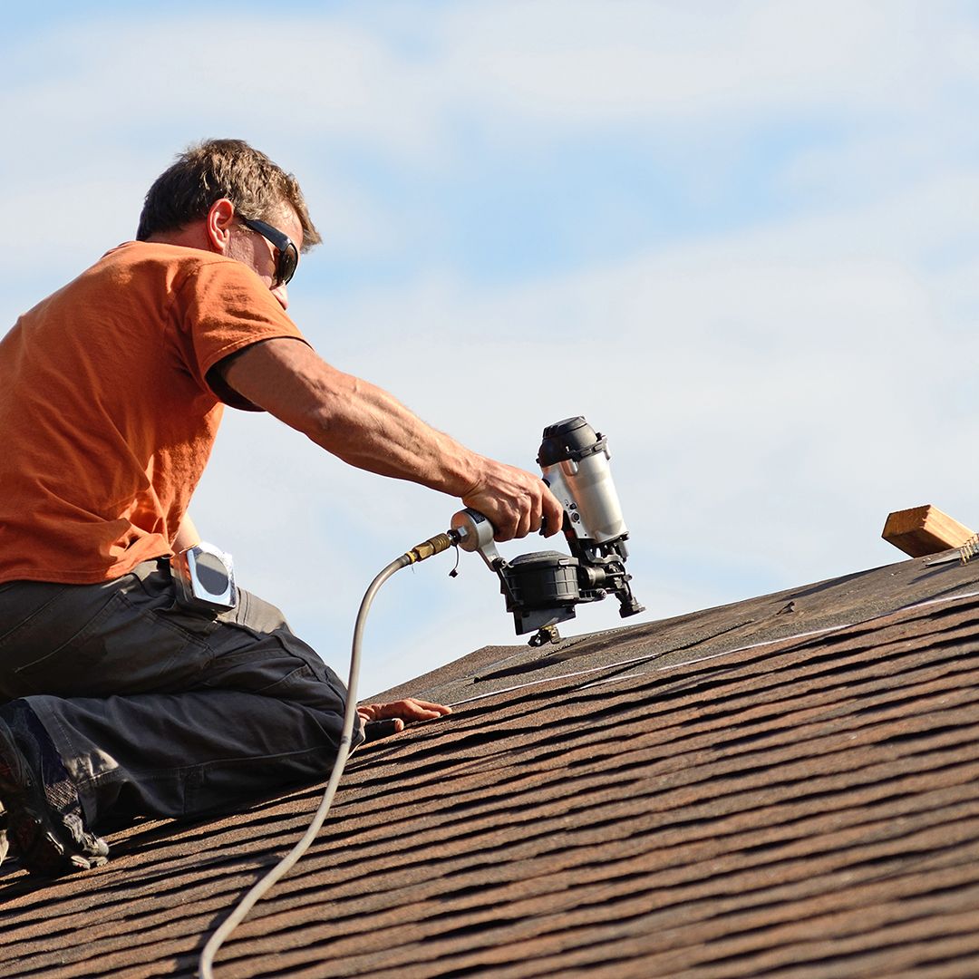 roofer installing an asphalt roof