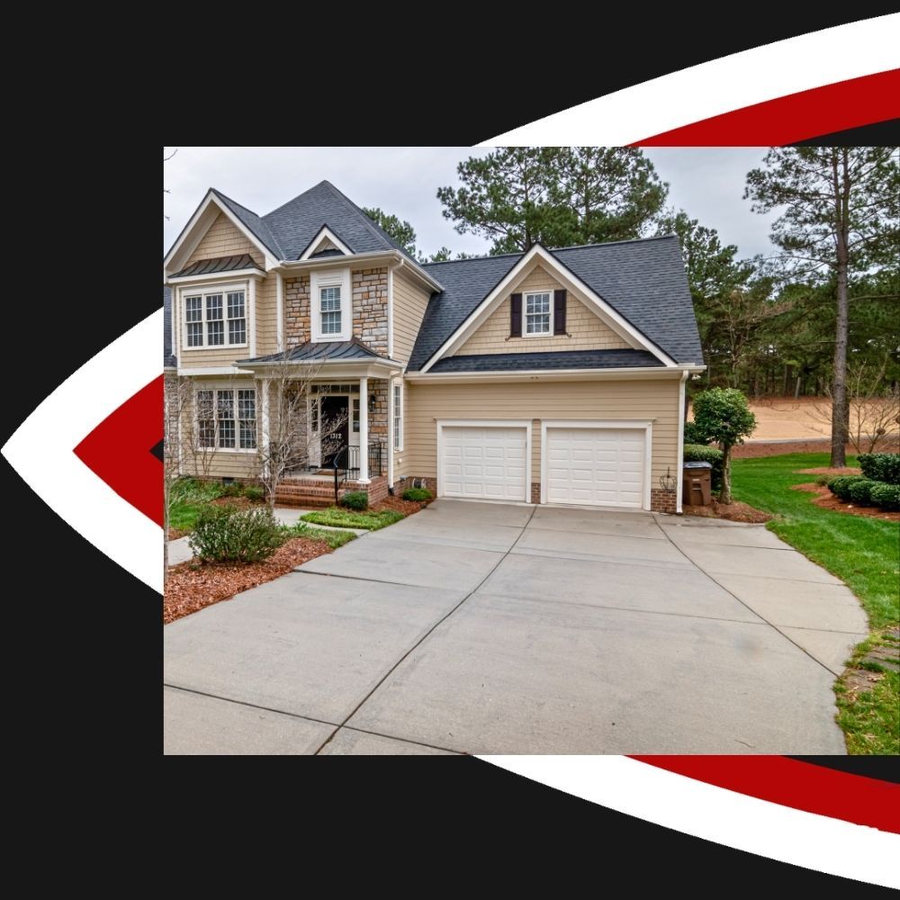 Concrete driveway leading to two-car garage of suburban home