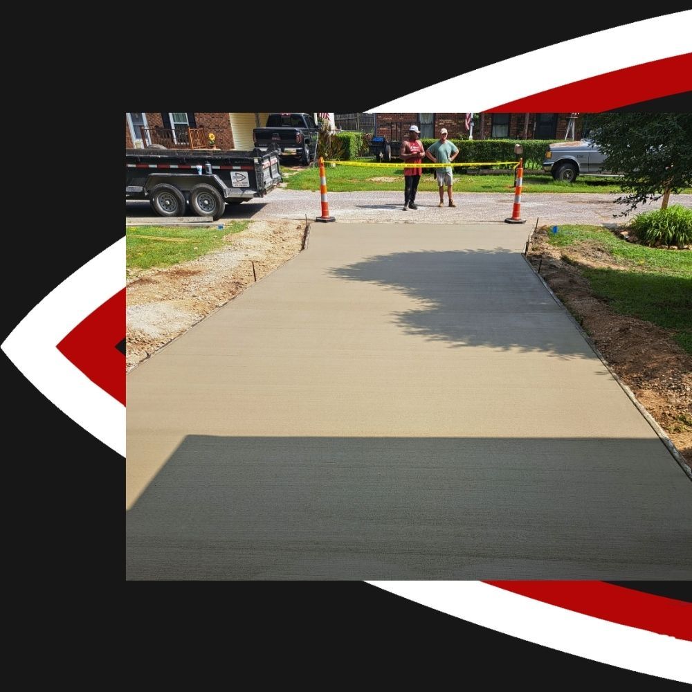 2 people standing at the end of a freshly completed driveway project