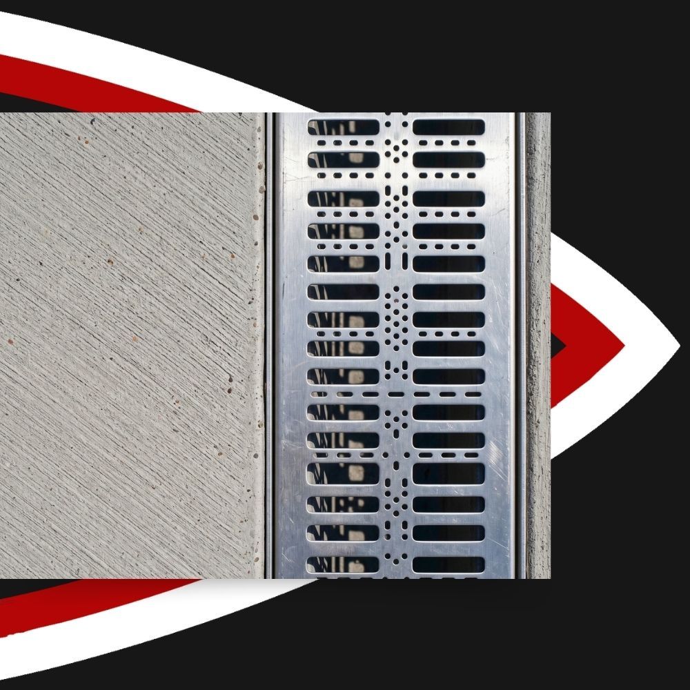 Metal trench drain grate installed flush with broom-finished concrete flatwork