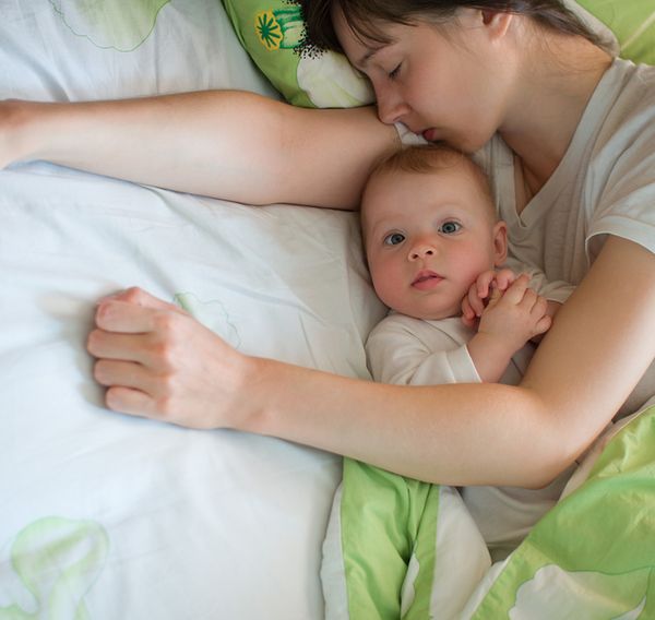 Image of a mom sleeping with her baby