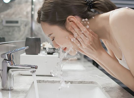 Image of a woman cleaning her face