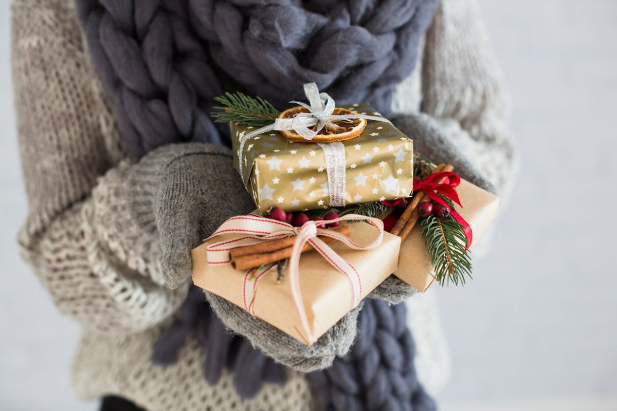 lady-mittens-with-heap-gift-boxes-hands.jpg