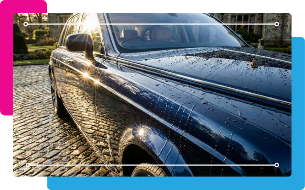 car with sunlight glinting off the surface, droplets of water sliding off the paint