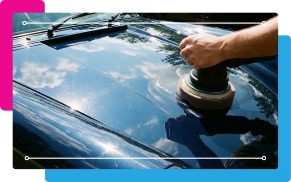 Close-up of a car hood being polished with a buffer