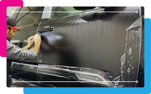 Paint protector film being applied to car