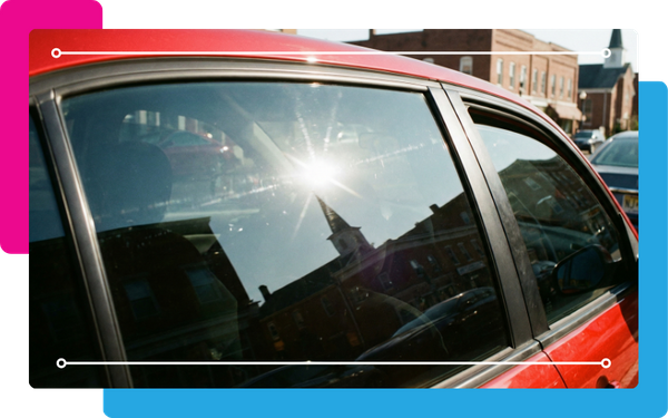 ed car's side window with a dark, reflective tint
