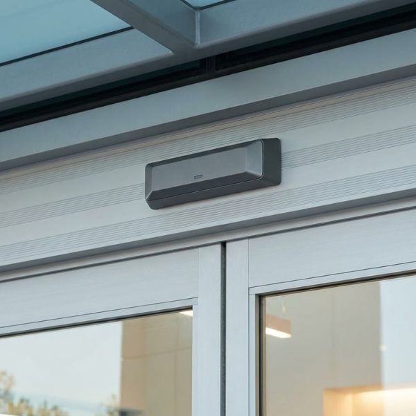 a sleek motion sensor mounted on the door header