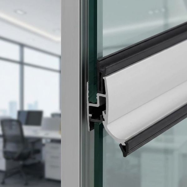 A detailed close-up shows the tight seal formed by weather stripping on an automatic glass door, enhancing energy efficiency