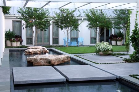 Landscaping, waterscaping, and stone work featuring a path over water