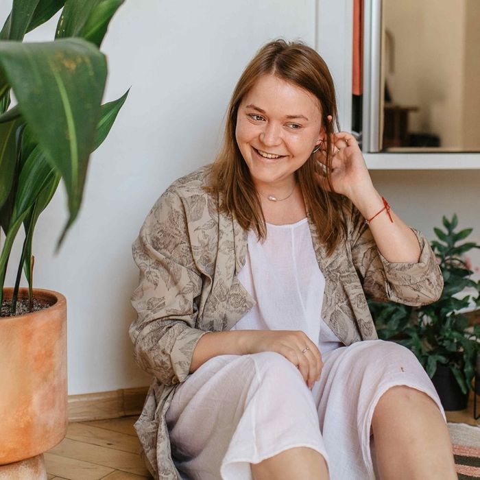 happy woman sitting with houseplantss