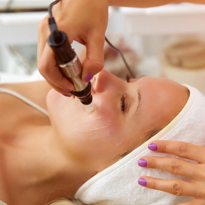 A focused image of a microneedling pen being used to stimulate collagen on a client's skin. microneedling.jpg