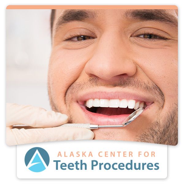 man smiling with dental implement in mouth, alaska center for teeth procedures