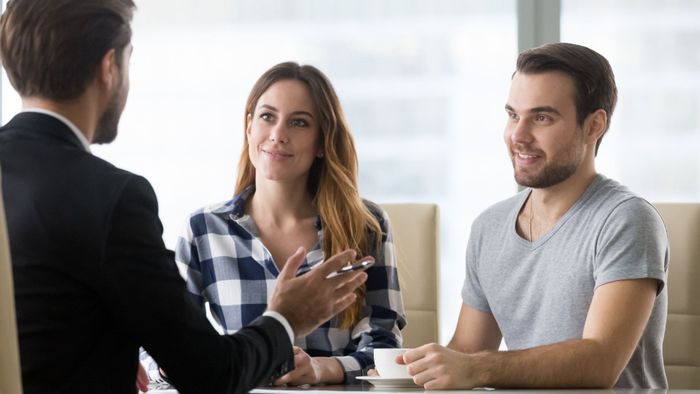 happy couple meeting with agent