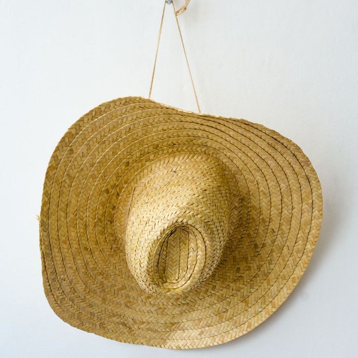 A straw hat hanging by its strap