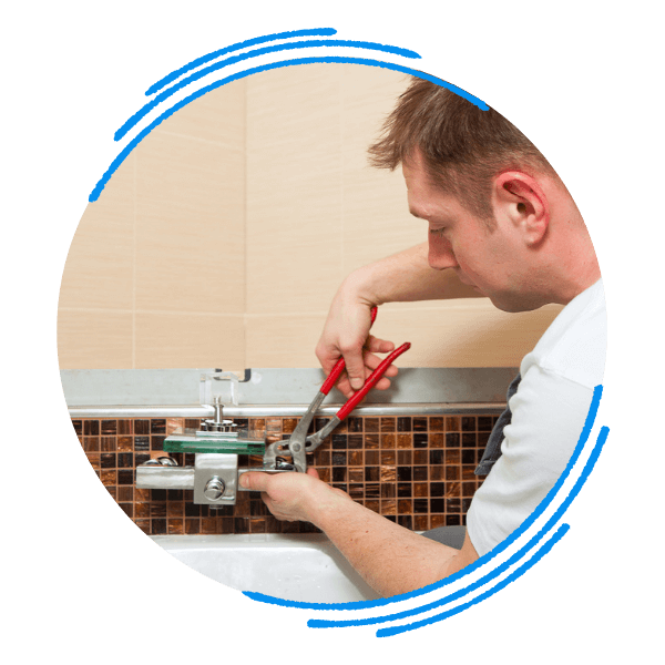 A plumber wearing a uniform focuses on connecting the pipes for a new bathtub installation. candler.png