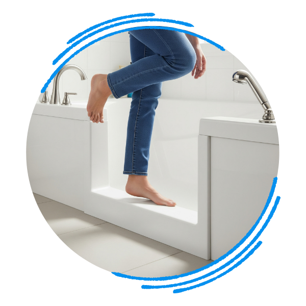 A close-up, low-angle view of a person's foot easily stepping over the low-threshold entry of an accessible bathtub.