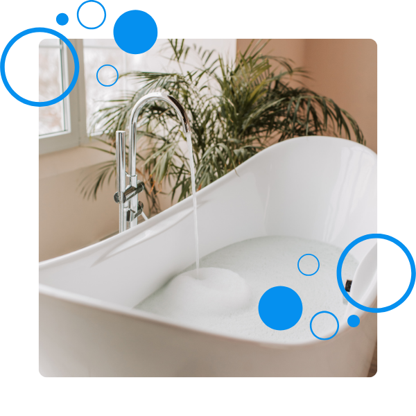 A tub filling with water and soapy bubbles