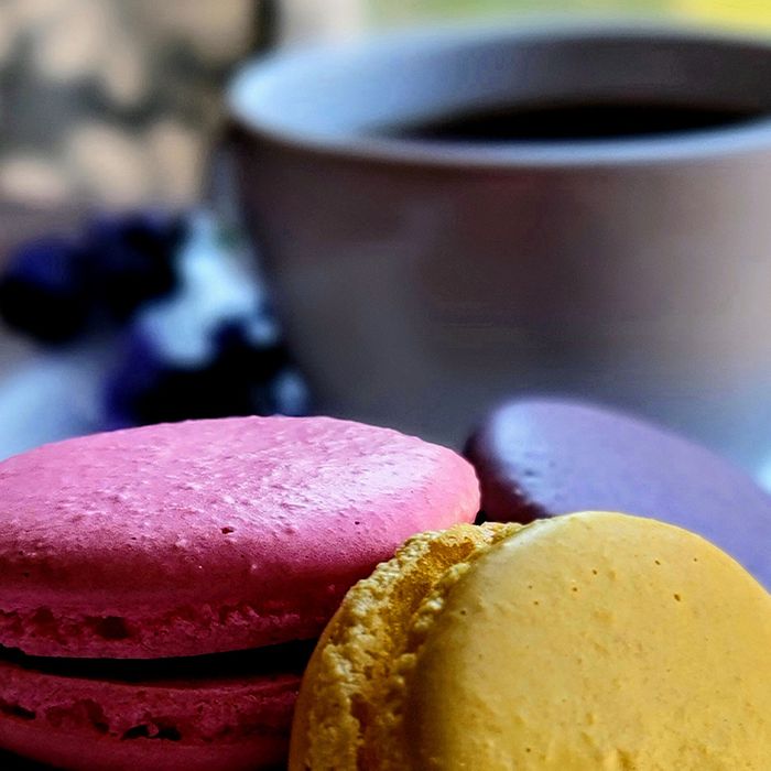 close up of macarons and a cup of coffee
