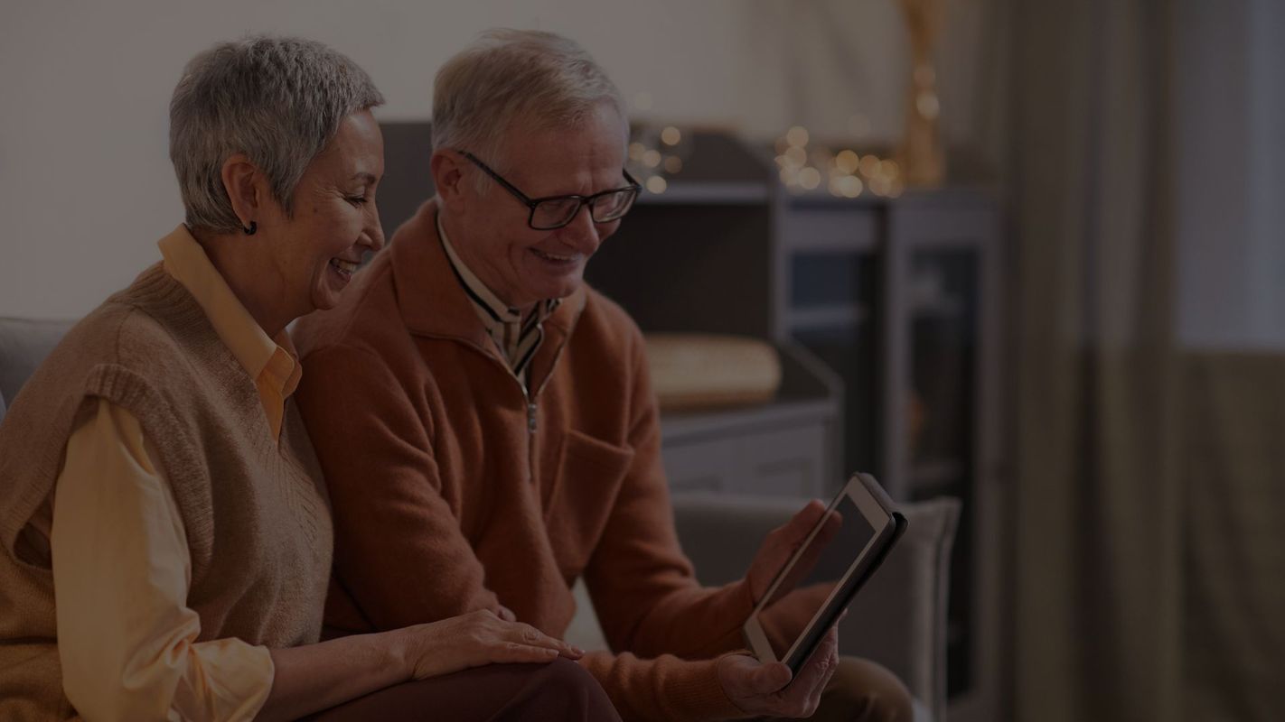 senior couple looking at a tablet