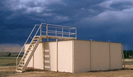 Modular MOBILE Shoothouse set up on level ground at a military tactical training facility.