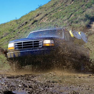 a truck driving through mud