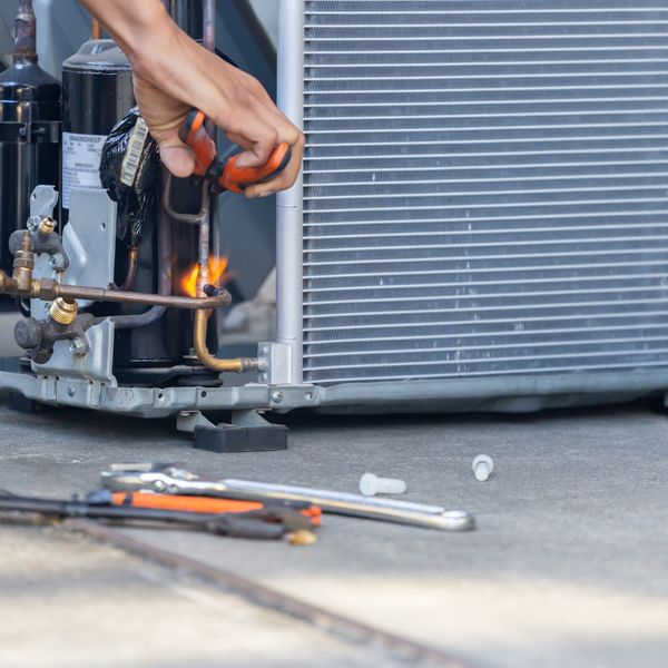 Using tools to repair an AC unit