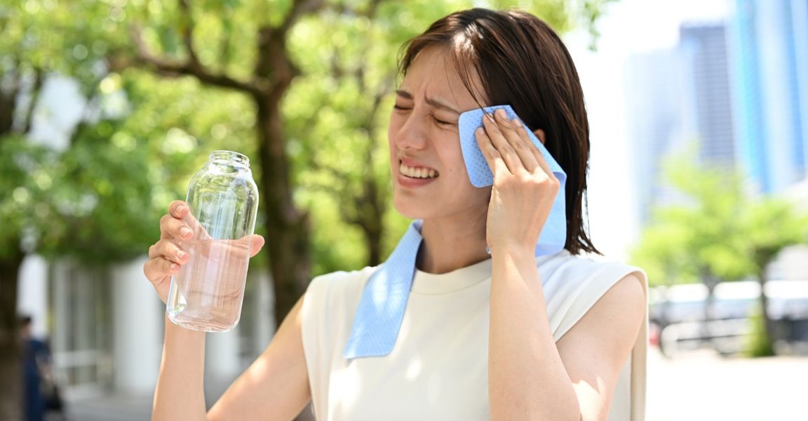 Woman wiping the sweat off her brow