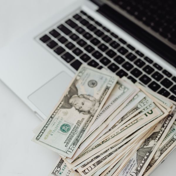 Pile of cash on a laptop