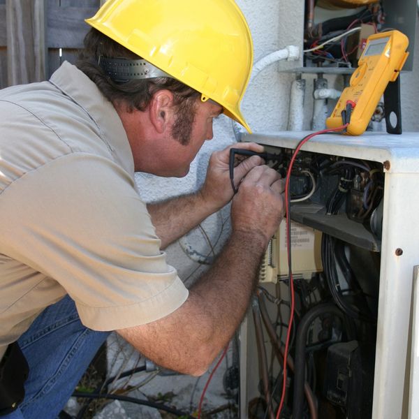 Man repairing an AC unit