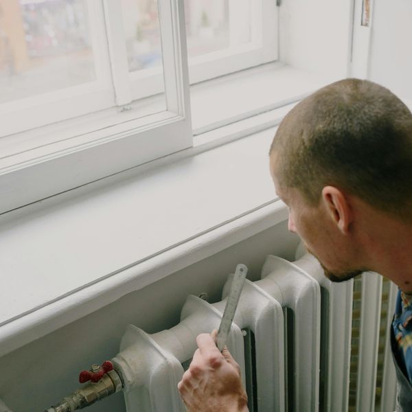 Man looking at his heating unit