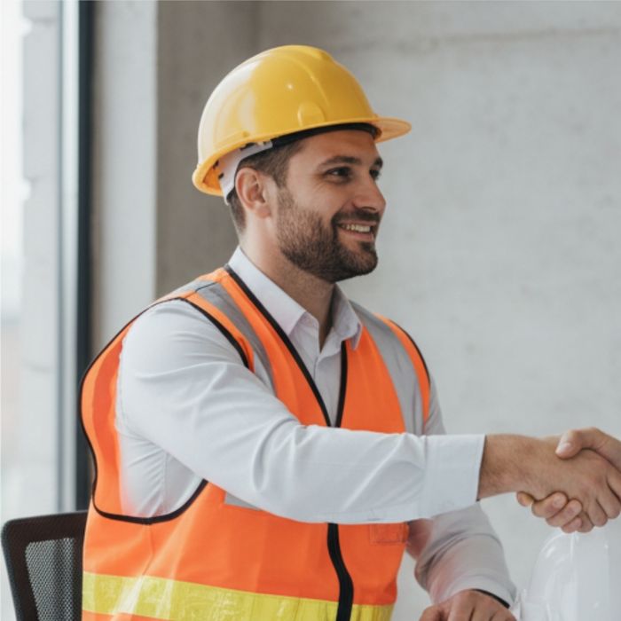 Construction manager shaking hands with a client