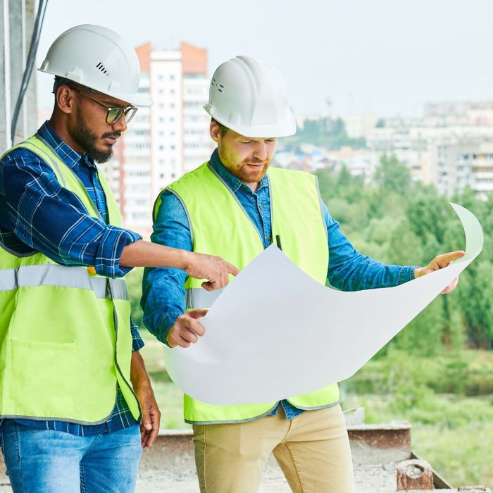 Two men looking at construction plans