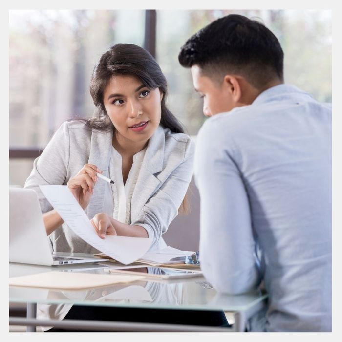 A women explaining a document to a man