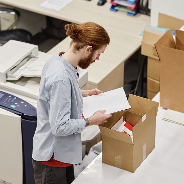 A person placing documents into a box