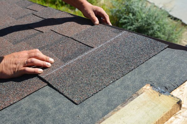 laying asphalt shingles