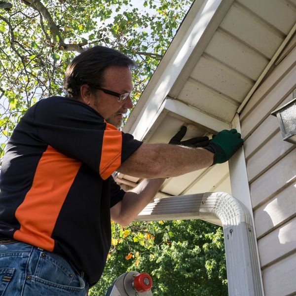 a man adding siding to a home