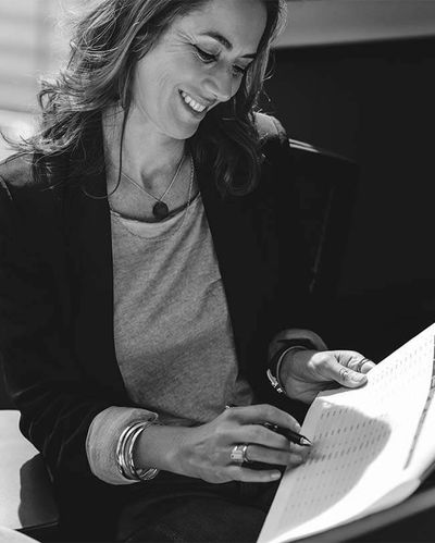 Woman smiling while looking at business papers
