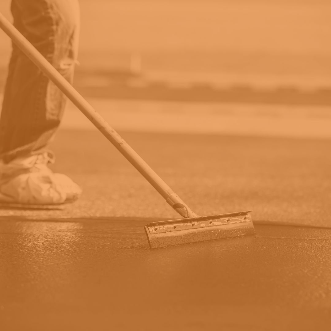 Sealcoating is a protective maintenance process for asphalt surfaces. A thin layer of sealant is applied to shield the asphalt from water, oil, and UV damage, which can cause it to become brittle and crack. This preventative measure extends the life of the pavement, enhances its appearance with a rich, black finish, and is a cost-effective way to protect your investment. Sealcoating