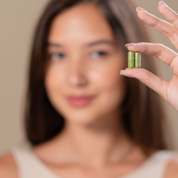 woman holding supplements.