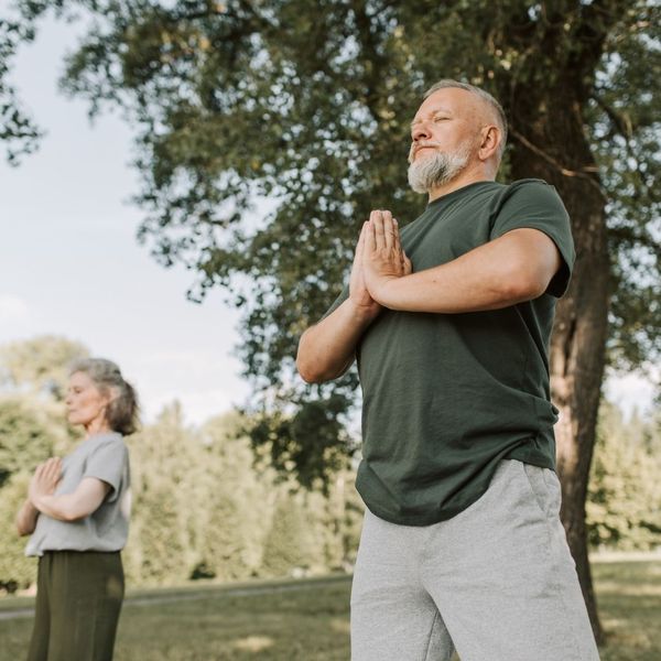 couple doing yoga outside 
