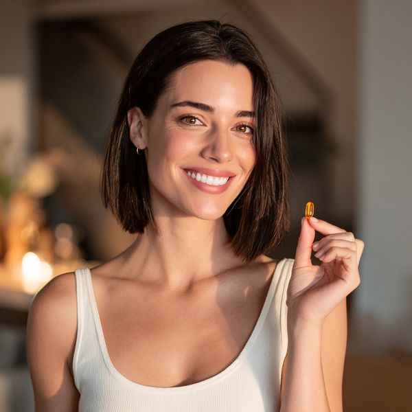 woman taking an all natural supplement