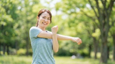 happy woman stretching outside